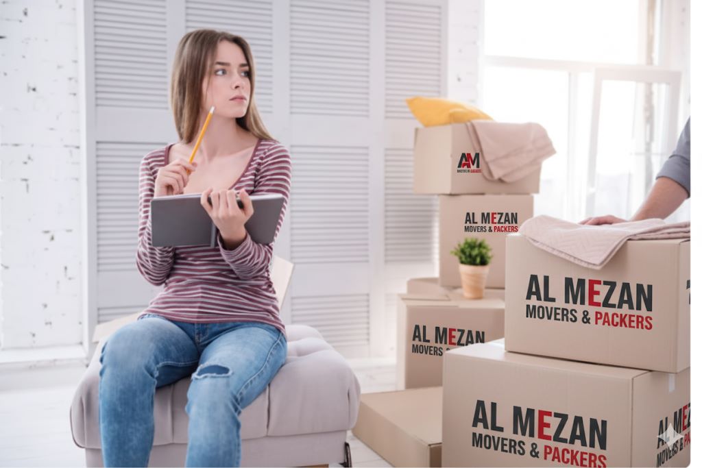 one lady with boxs having logo of Al Mezan Movers & Packers